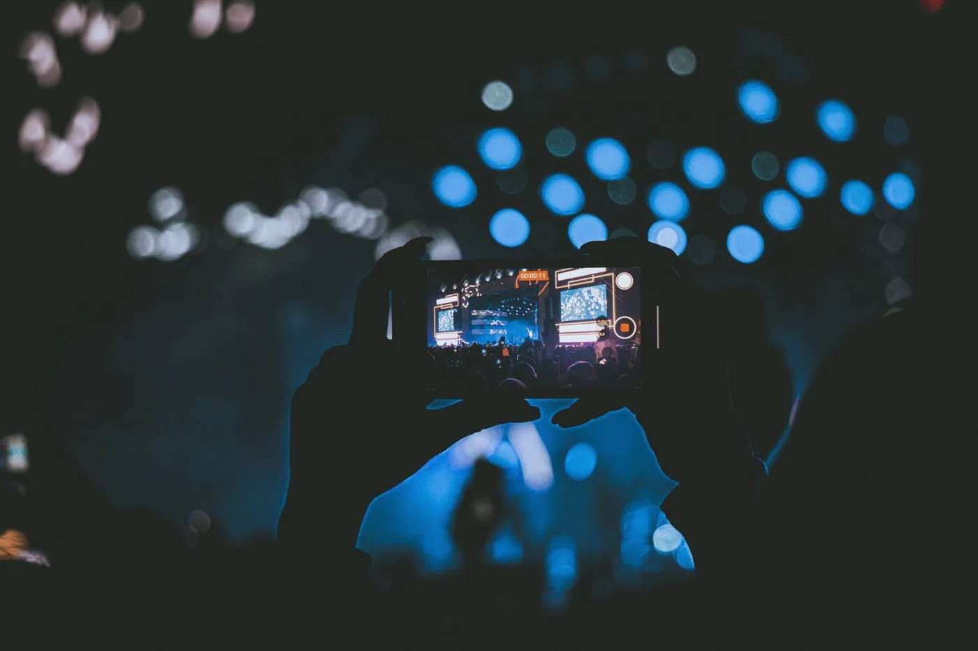 A phone held up in a crowd at a show