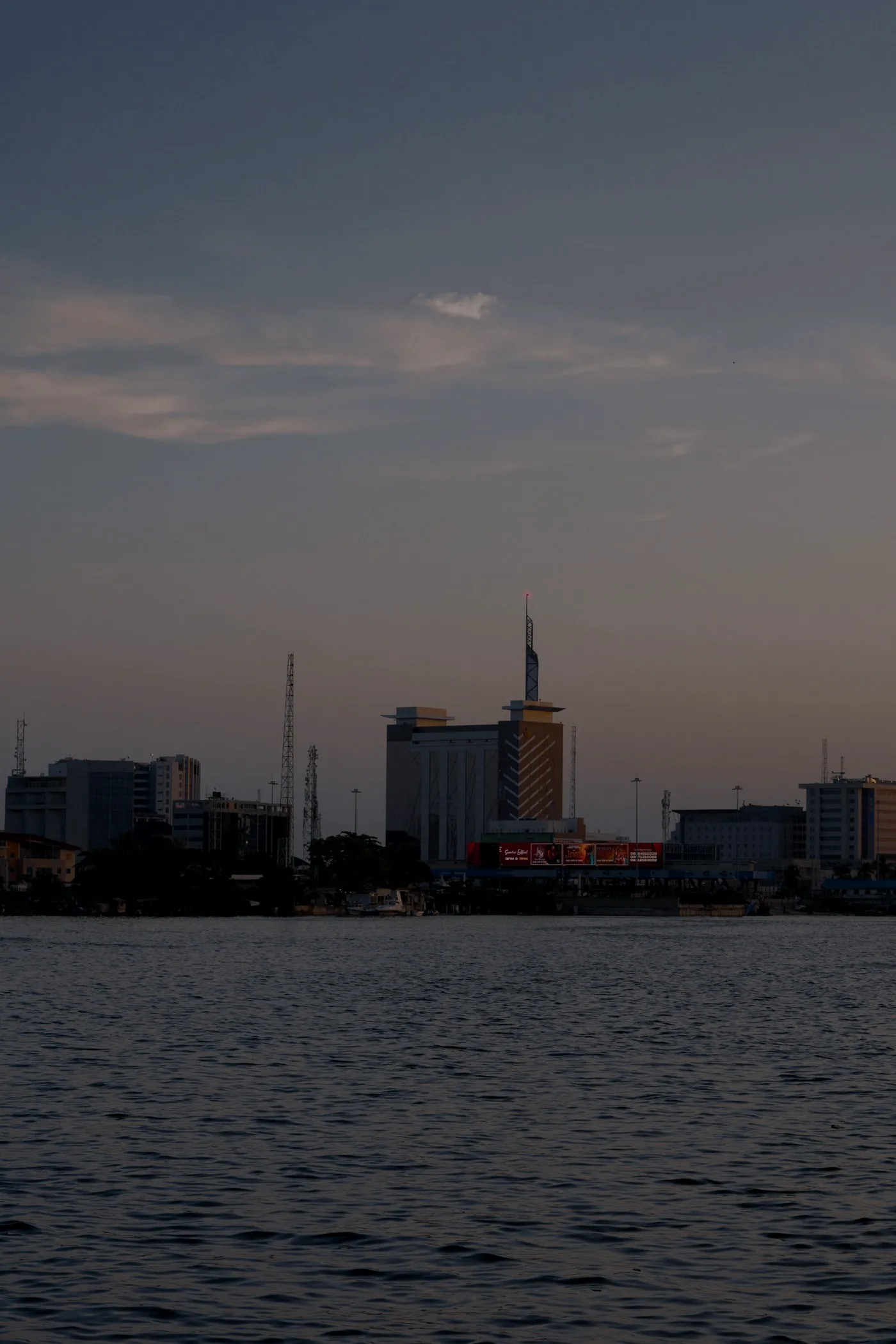 A city skyline at dusk across the water